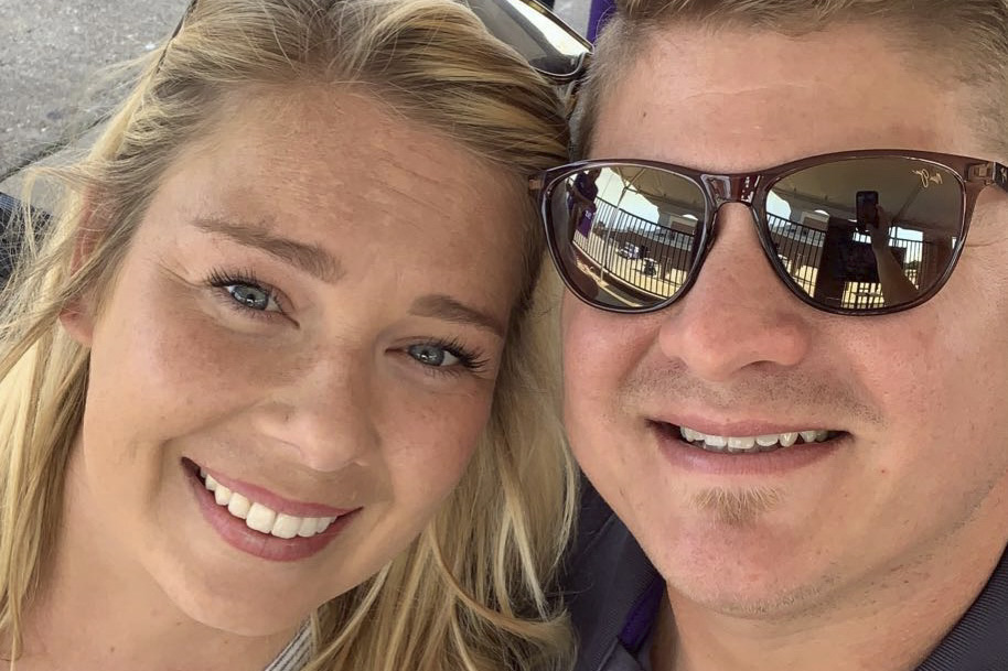 Closeup of Justin Slemmons wearing sunglasses smiling with his wife.