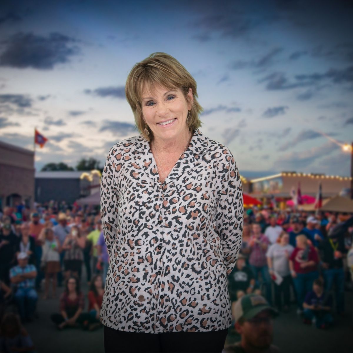 Christie Beyer, Board Member at Bacon Bash Texas with ABF Packing, smiling in a pink blouse at the lively festival gathering.